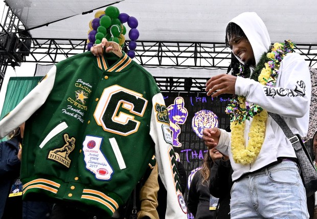 Heisman Trophy winner and 2019 Cajon High graduate Jayden Daniels reacts as he receives a letterman jacket from his former high school during a homecoming ceremony for the LSU quarterback at the San Bernardino school Saturday, Jan. 20, 2024. (Photo by Will Lester, Inland Valley Daily Bulletin/SCNG)