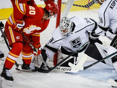 Kings goalie Cam Talbot, right, defends the goal from Calgary’s Blake Coleman, left, during the first period Tuesday, Feb. 27, 2024, in Calgary, Alberta. (Jeff McIntosh/The Canadian Press via AP)

