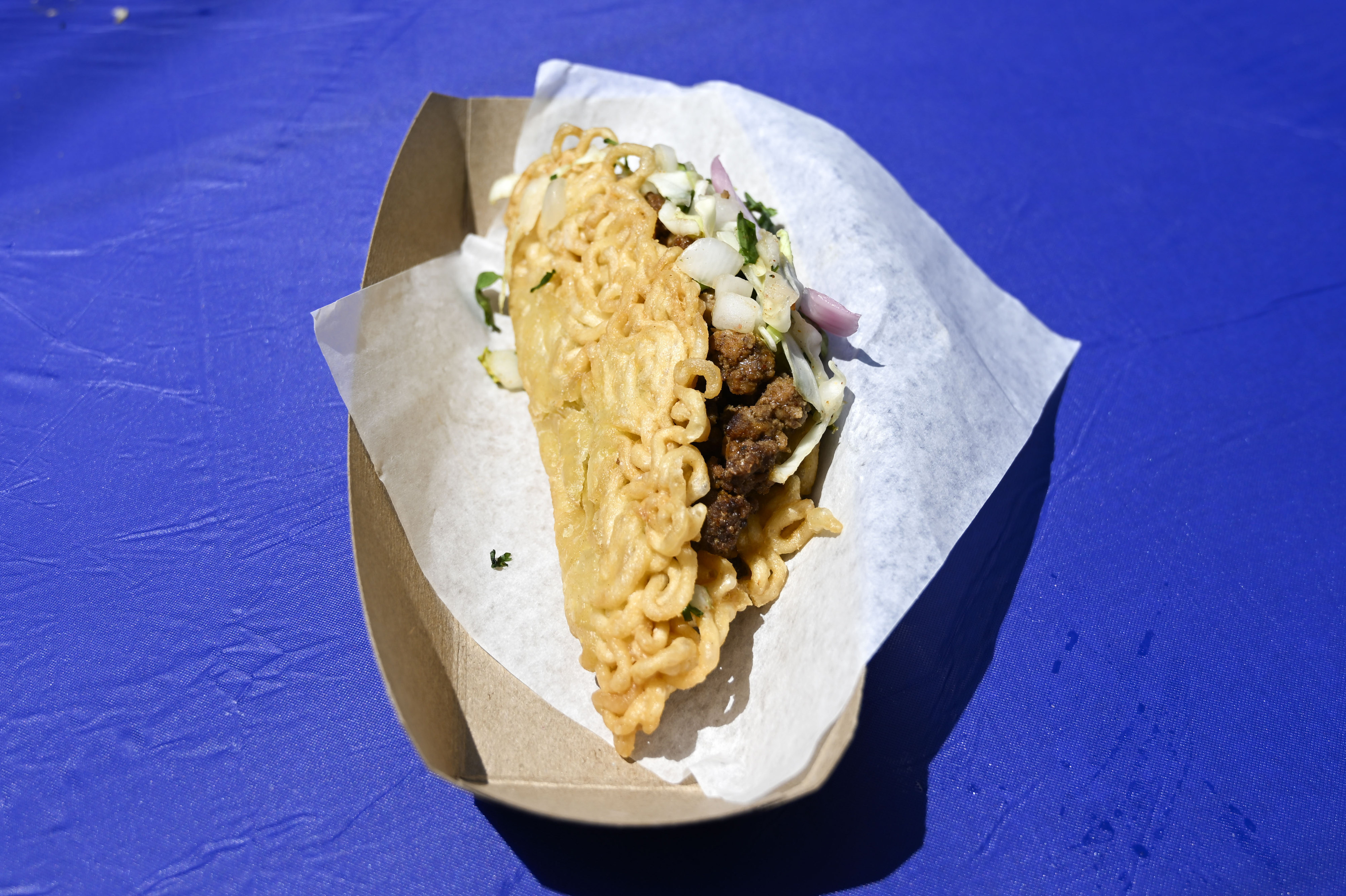 Ramen Taco’s Kung Pao beef, slaw and red onions in...